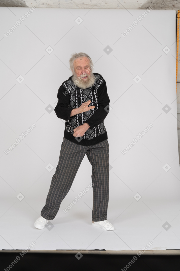 Old man pulling his hand towards camera