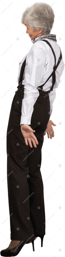 Side view of a careless old lady in office clothing outspreading her hands