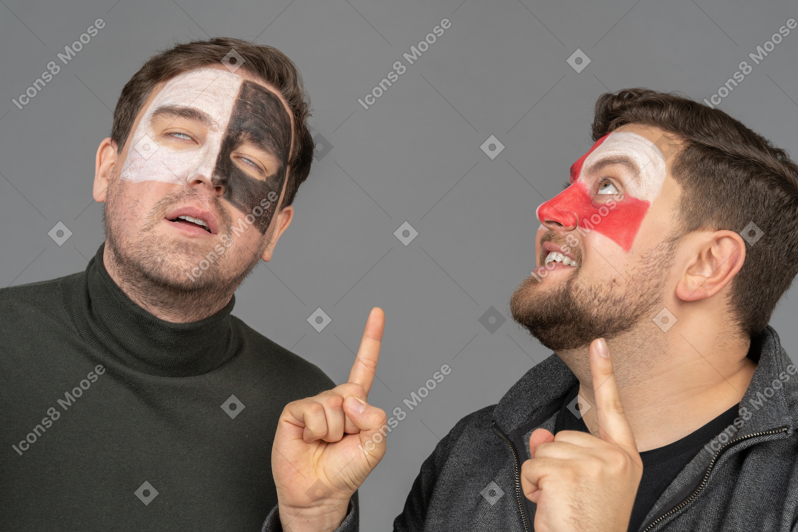 Front view of two male football fans pointing fingers and rolling eyes
