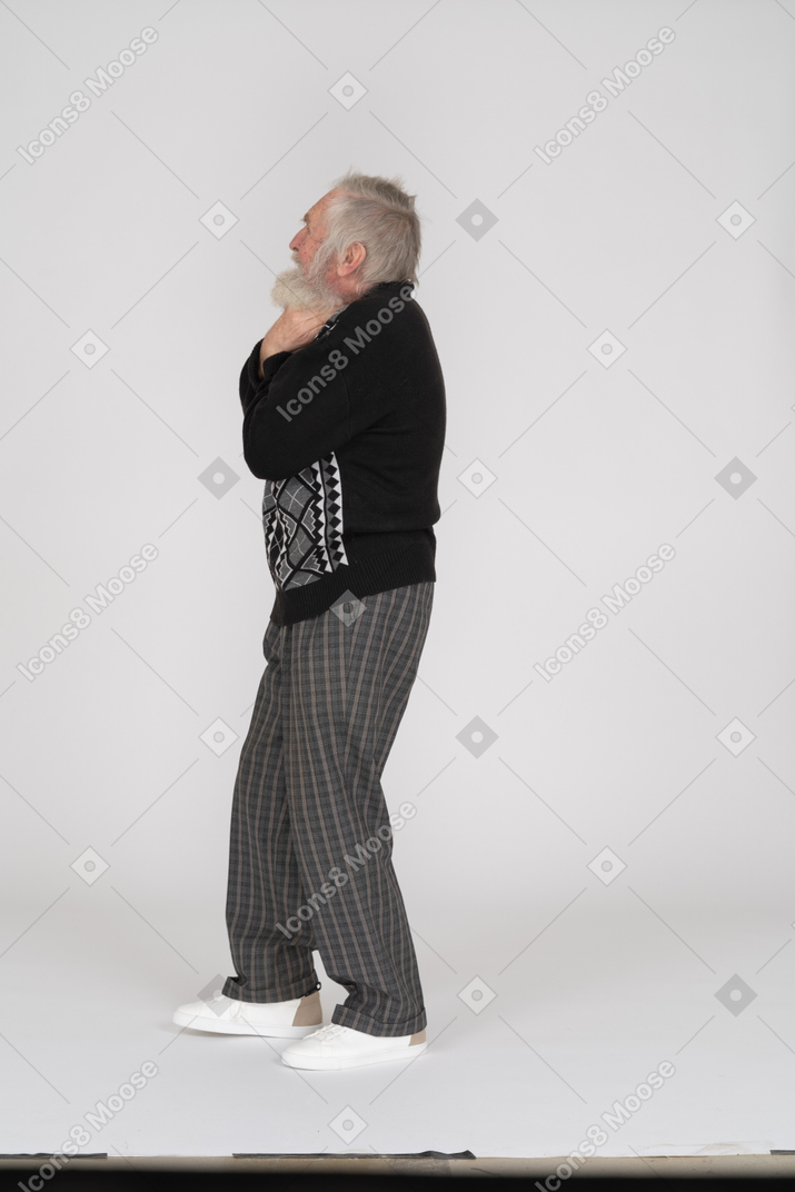 Side view of a senior man choking himself