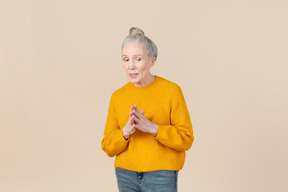 Elegant older woman in a mustard sweater