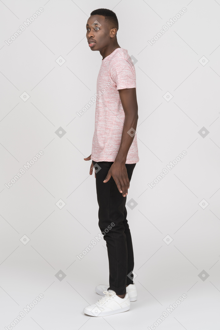 Standing young man looking startled