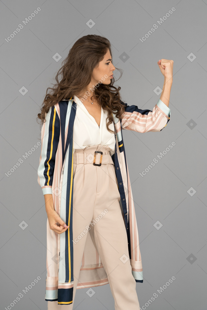 Young woman shaking a fist