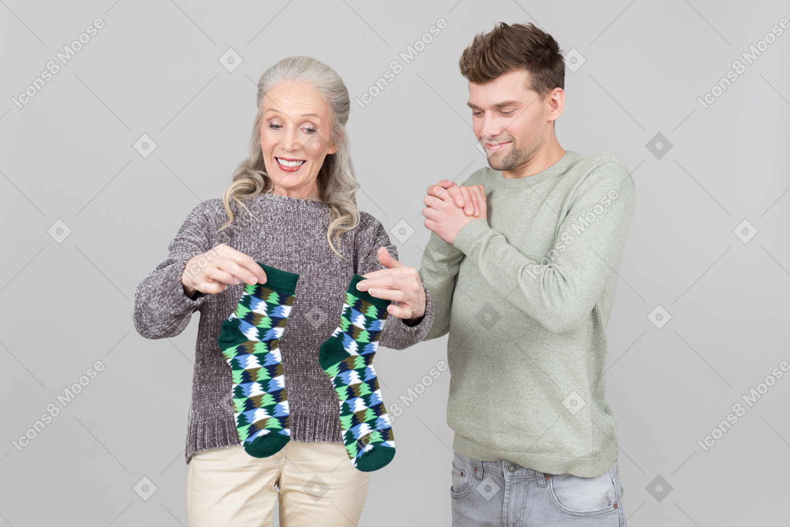 Elegant old woman giving socks as a present to a young guy