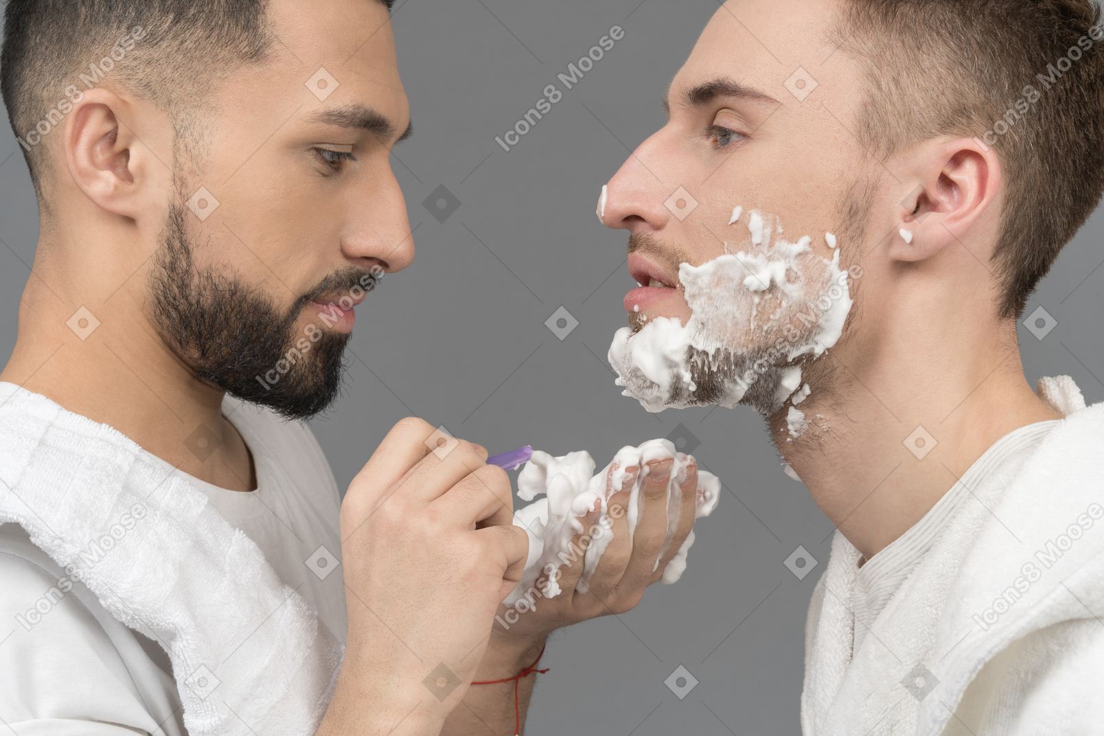 Close-up of a man shaving his boyfriend's face