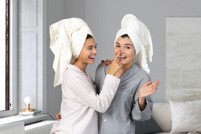 Women with towels on their heads fooling around