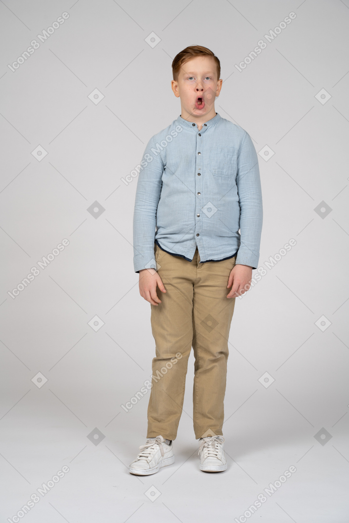Front view of a cute boy making faces
