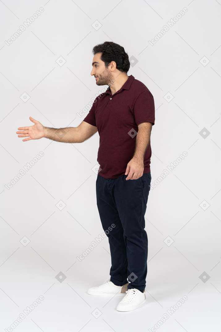 Smiling man in casual clothes offering handshake