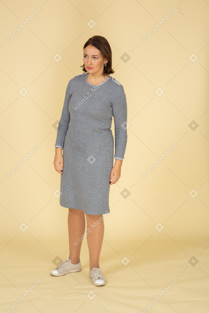 Front view of a sad woman in grey dress