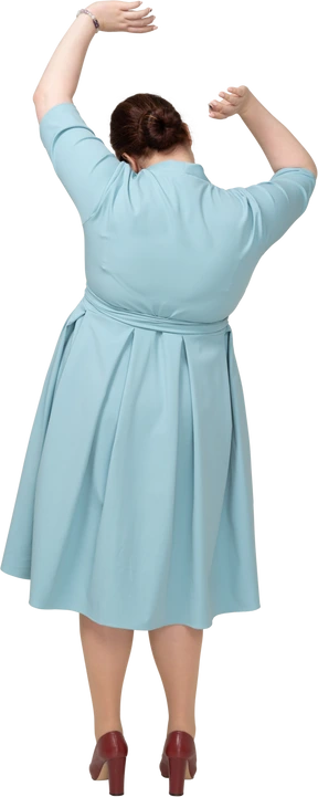 Rear view of a woman in blue dress dancing
