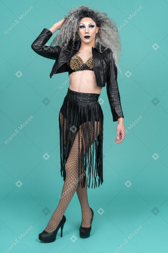 Drag queen in black leather jacket posing with hand behind head