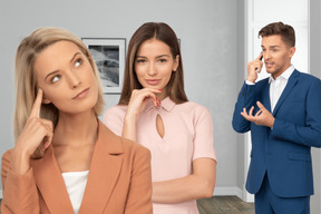 Thoughtful women standing next to a man