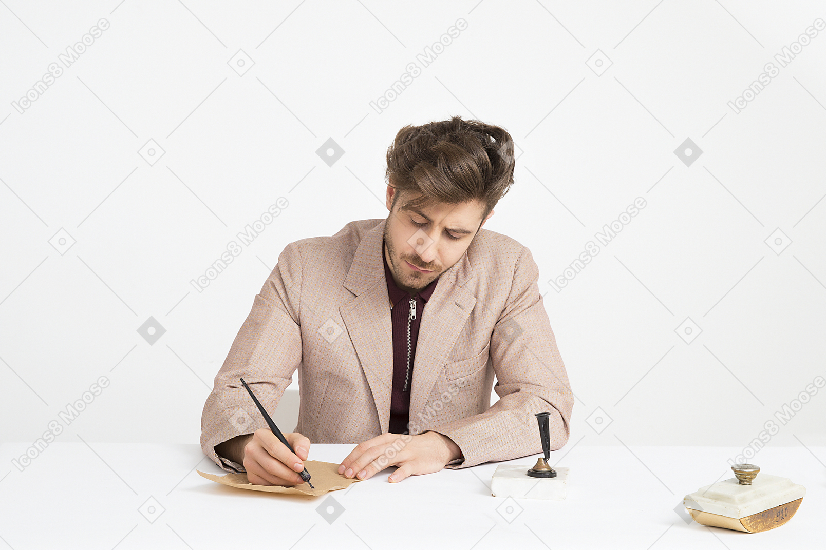 Handsome young man holding pen and writing a letter