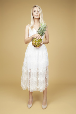 Beautiful bride holding a pineapple