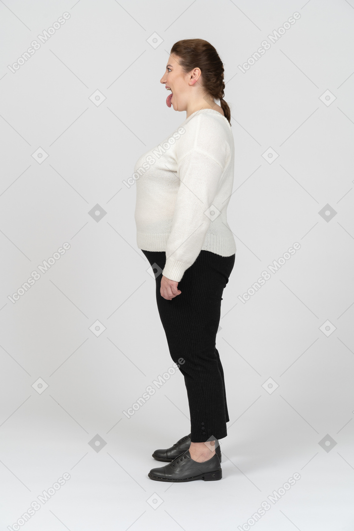 Plump woman in casual clothes making faces