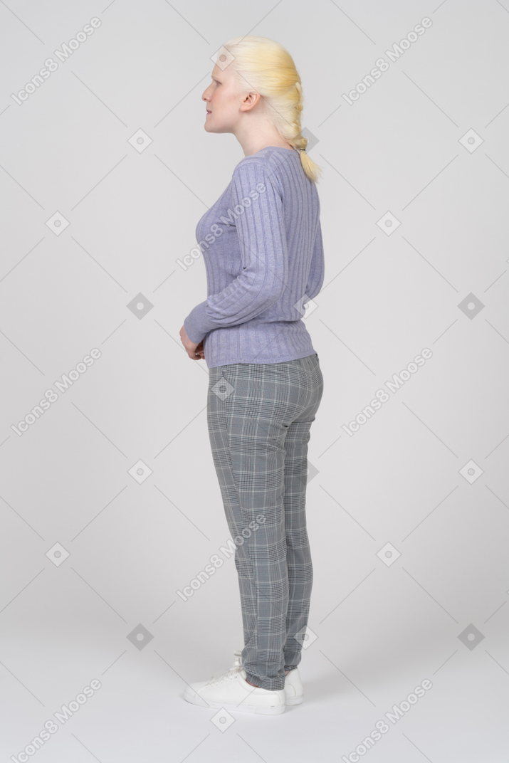 Rear view of a woman in casual clothes standing