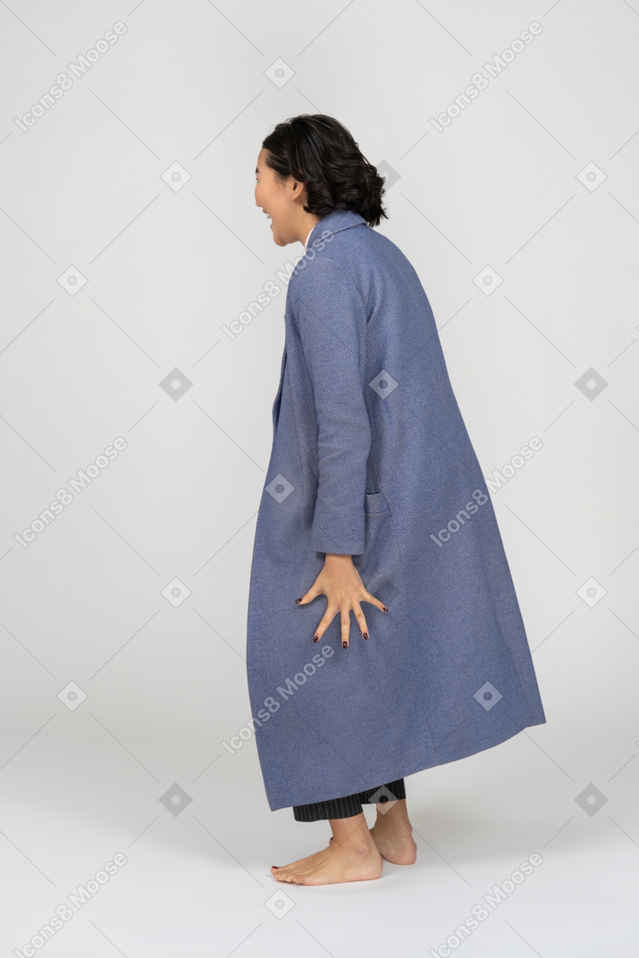 Vista posteriore di una donna in cappotto che grida