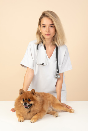 Attractive veterenarian ready to examine a spitz