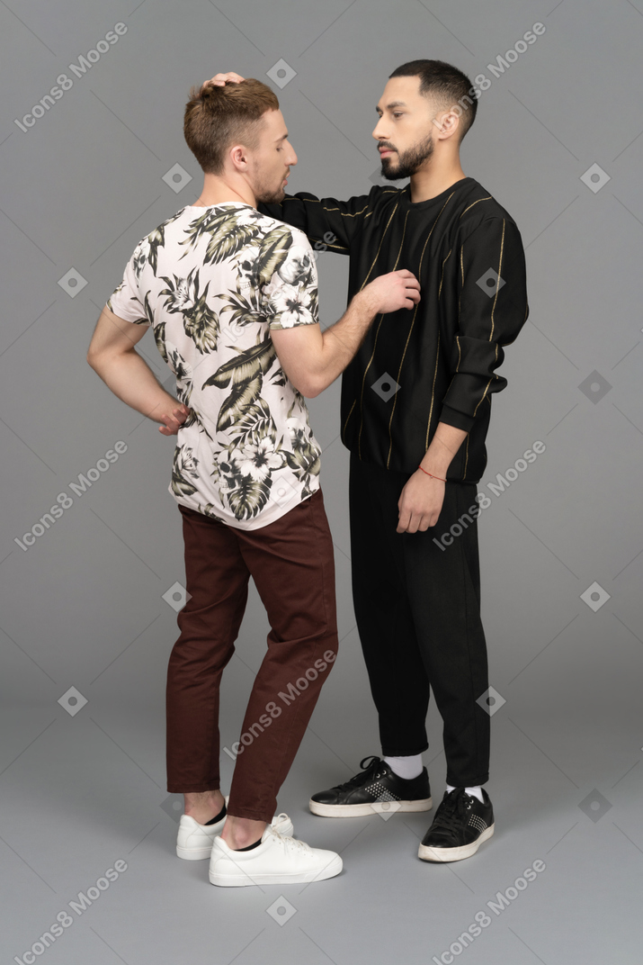 Two young men touching each other lightly