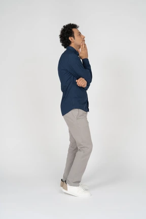 Side view of a man in casual clothes thinking
