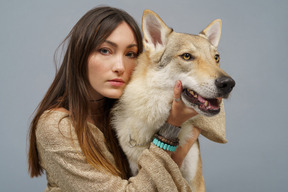 両方のカメラを見ている彼女の犬と女性のマスターのクローズアップ