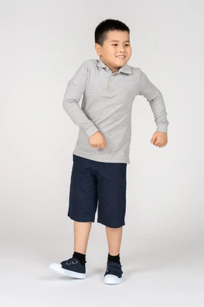 Cheerful little boy dancing