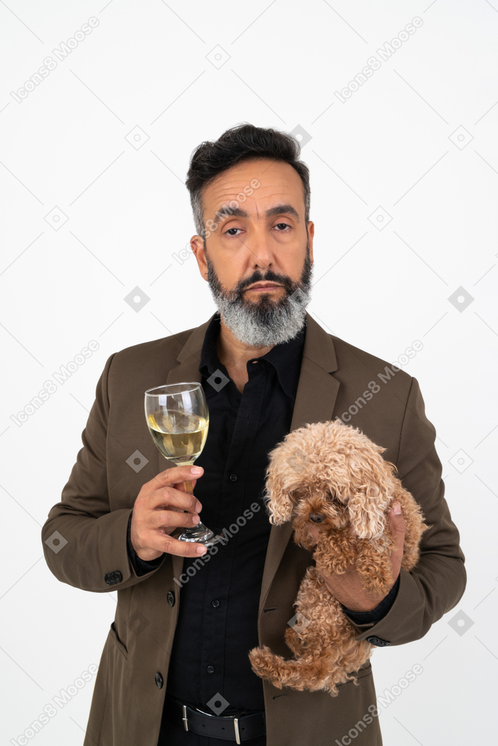 Mature man holding a dog and glass of wine
