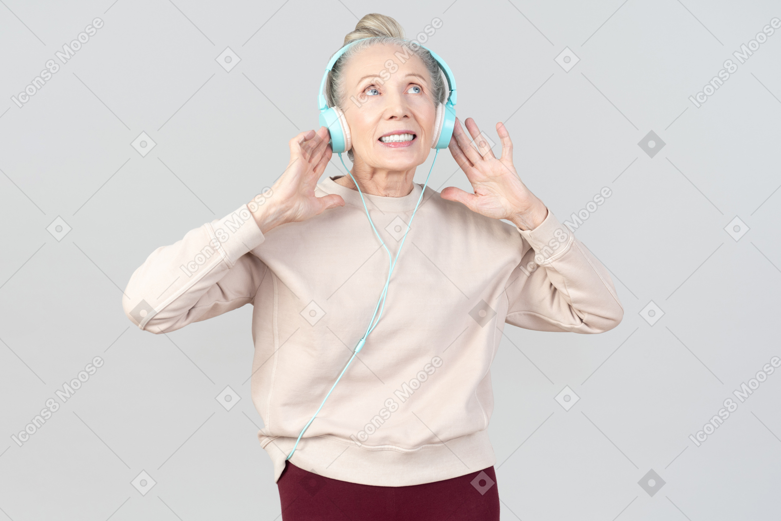 Old lady in listening music in headphones