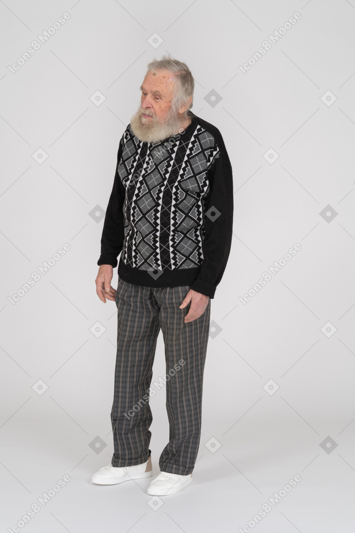 Elderly man standing and looking down
