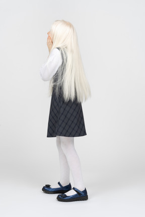 Side view of a schoolgirl with long platinum hair