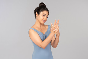 Young indian woman applying hand cream