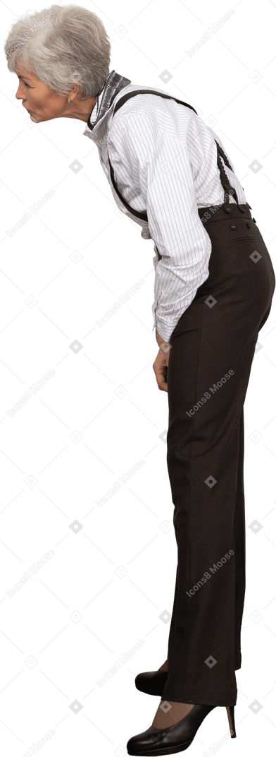Side view of a curious old lady in office clothing leaning forward
