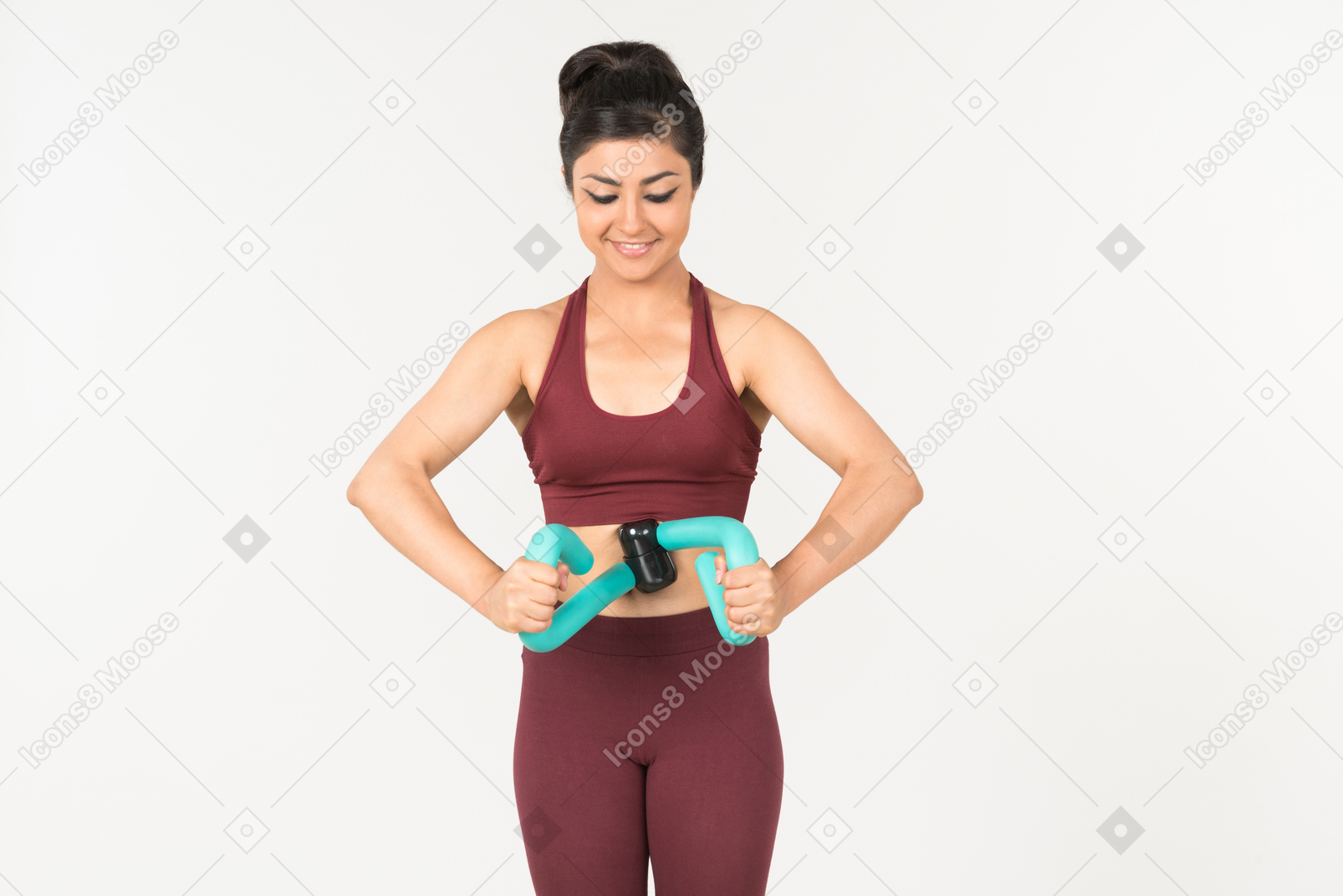 Young indian woman in sportswear holding hand expander