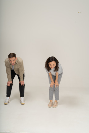 Smiling young man and woman catching breath