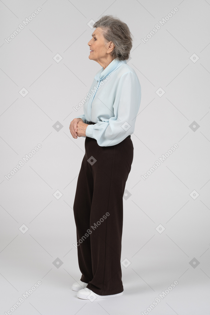 Side view of an old woman clasping hands