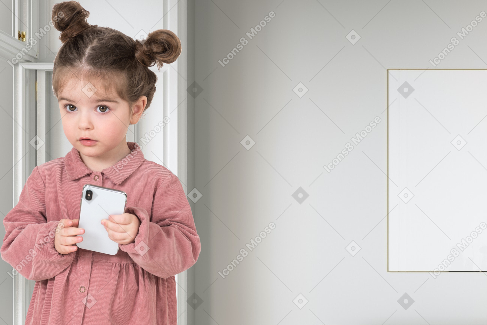 A little girl holding a phone in her hands