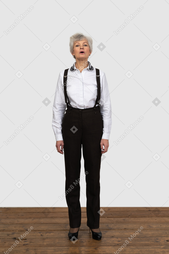 Front view of an old female in office clothes talking