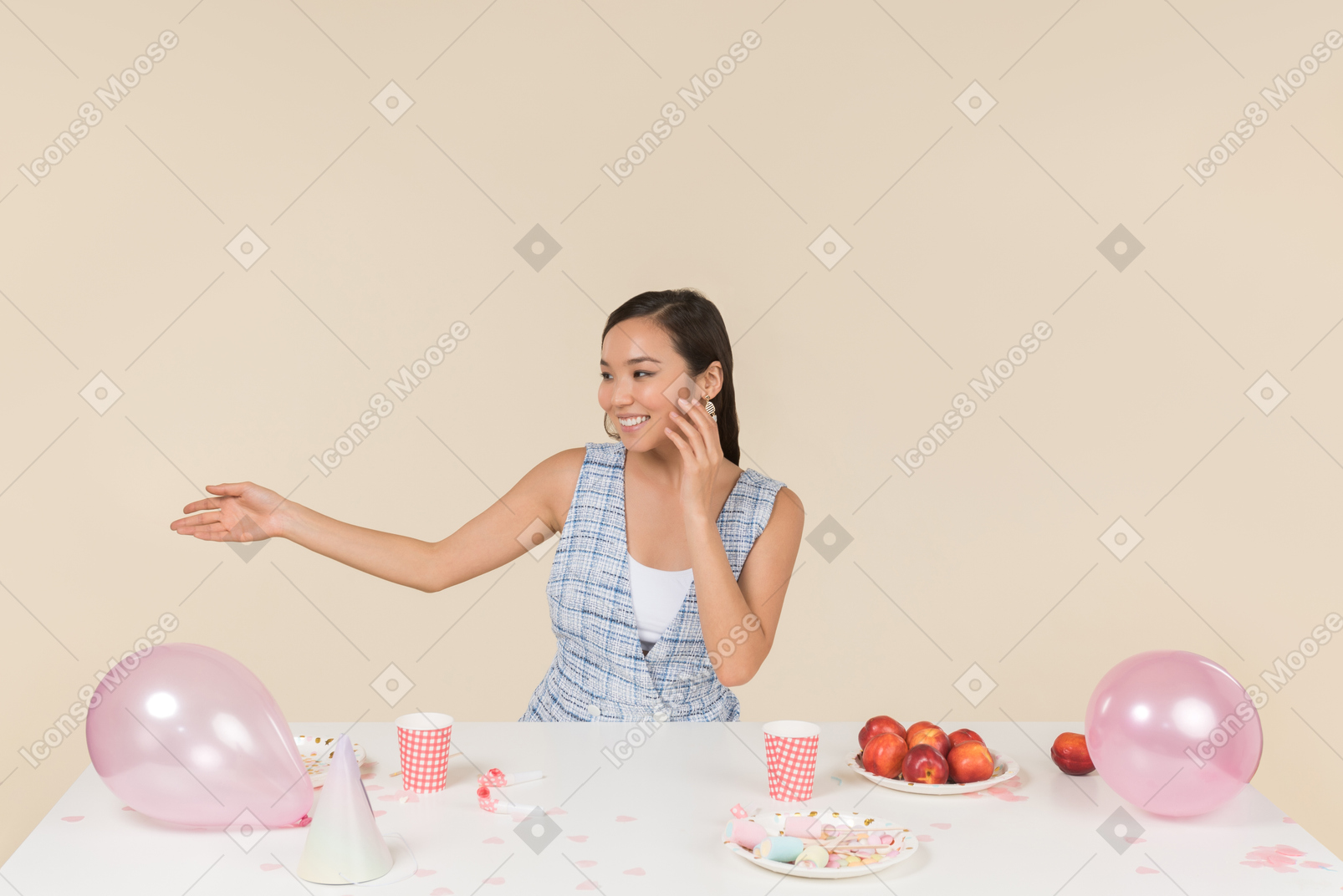 Contented young asian woman sitting at the birthday table