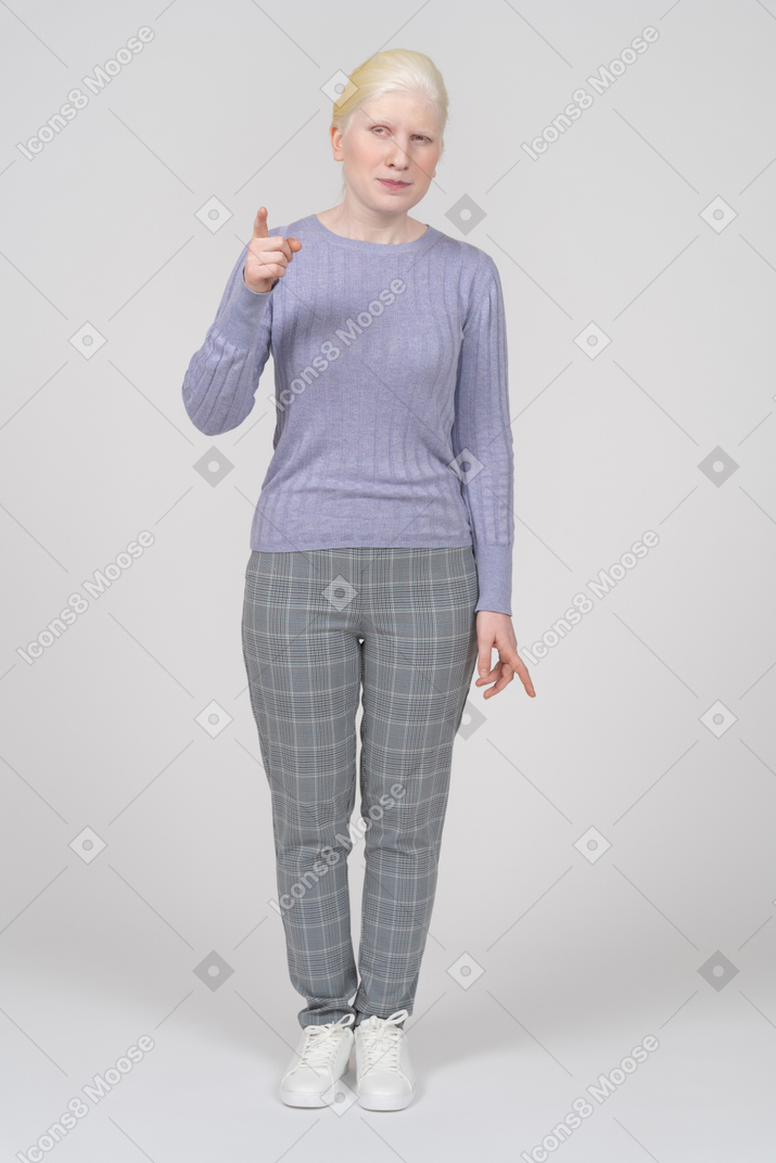 Suspicious young woman pointing