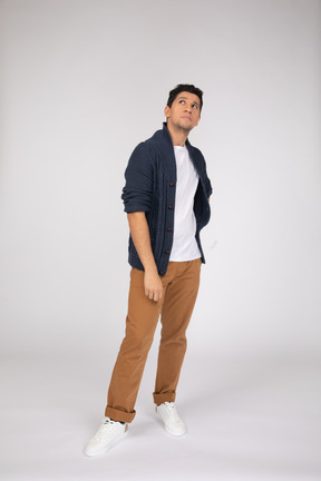 Man in casual clothes standing and looking up
