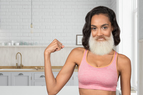 A woman with a white beard and a pink sports bra