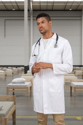A doctor standing on a hospital background