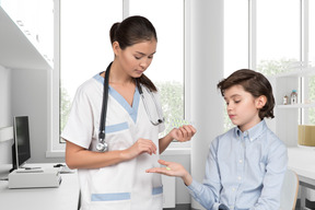 A female doctor giving boy a medicine