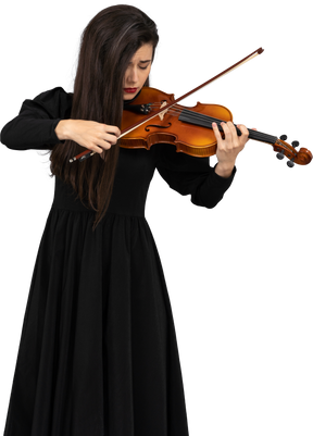 Primo piano di una giovane donna emotiva in abito nero a suonare il violino