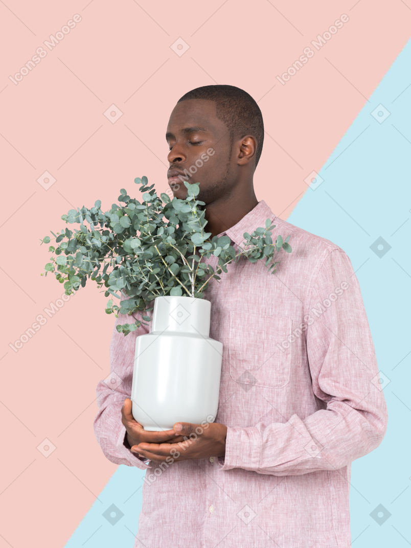 A man holding a potted plant in his hands