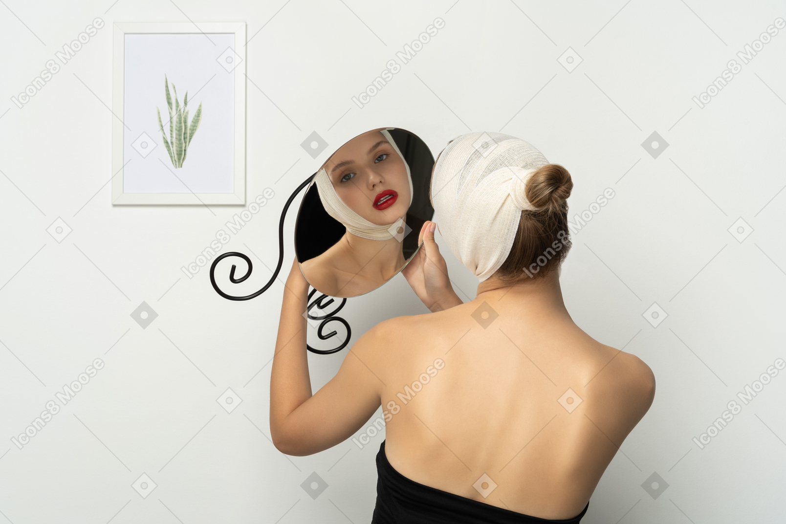 Young woman with bandaged head holding up a mirror