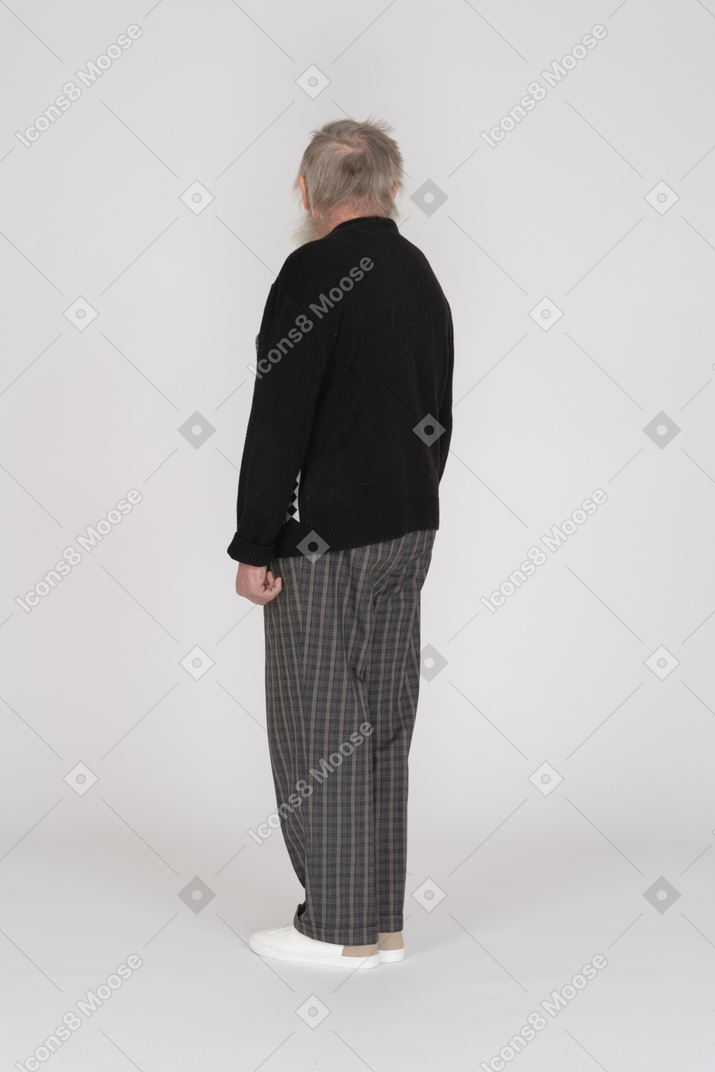 Rear view of old man looking over shoulder