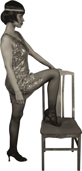 American flapper posing in profile with one leg on a chair
