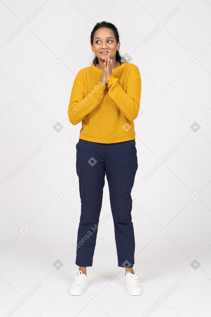 Front view of a happy girl in casual clothes rubbing hands