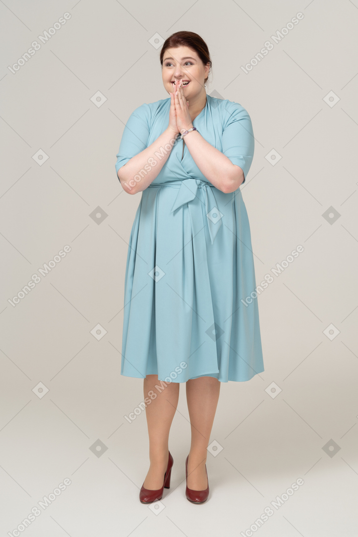 Front view of a happy woman in blue dress